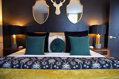 a bedroom with a bed with blue walls and mirrors at HostWise Stays - Grandview Balcony with Stunning Skyline Views in Pittsburgh