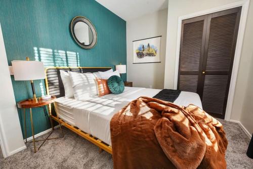 a bedroom with a bed with a blanket on it at HostWise Stays - Grandview Balcony with Stunning Skyline Views in Pittsburgh