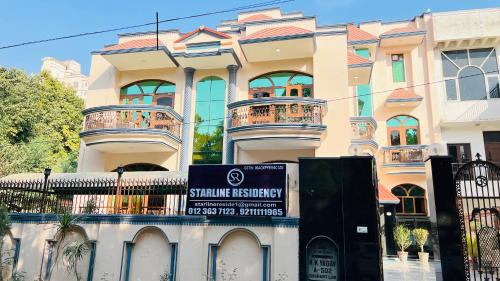 a building with a sign in front of it at Hotel Starline Sector 28 in Gurgaon
