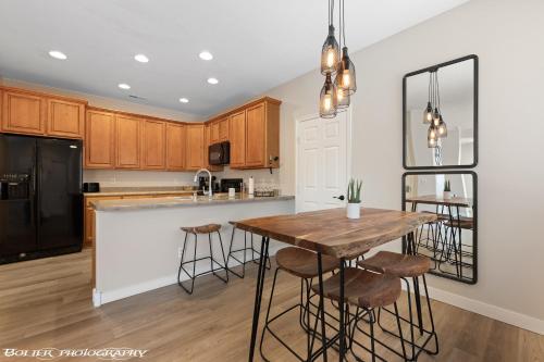 a kitchen with a wooden table and a black refrigerator at Beautiful Condo at the Springs By Cool Properties in Mesquite