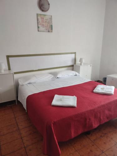 a bedroom with a bed with two towels on it at Hotel Italia in Reggio Emilia