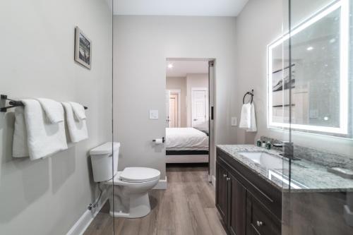a white bathroom with a toilet and a sink at Riverside Inn in New Glasgow