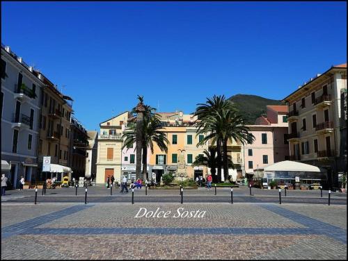 a city square with buildings and palm trees in a city at Dolce Sosta in Ceriale