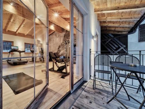 a room with a gym with a glass wall at Hotel Mariasteinerhof in Mariastein