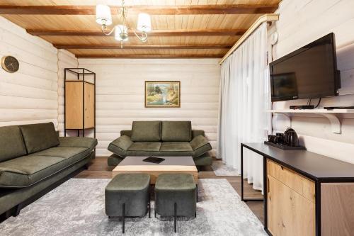 a living room with two couches and a tv at Korona Hotel&SPA in Bukovel