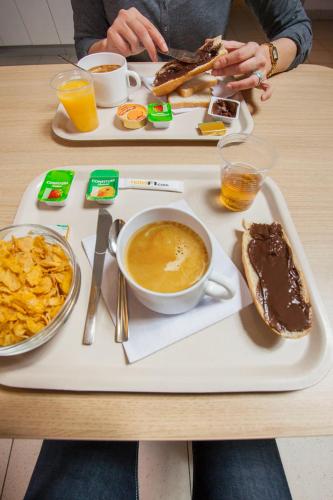 a tray with a plate of food on a table at Unisotel Colmar Parc Des Exposition EX F1 in Colmar