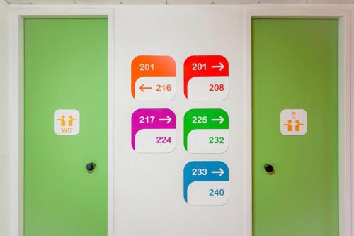 a room with two doors with different numbers on them at Unisotel Colmar Parc Des Exposition EX F1 in Colmar