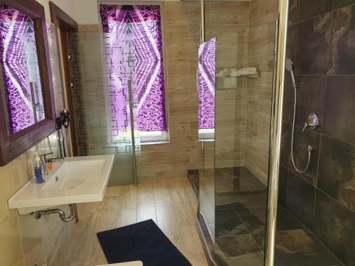 a bathroom with a shower and a sink at Kasumai Beach Resort in Bijilo