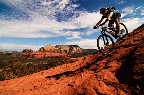 a person riding a bike on the side of a mountain at Beautiful Condo at the Springs By Cool Properties in Mesquite