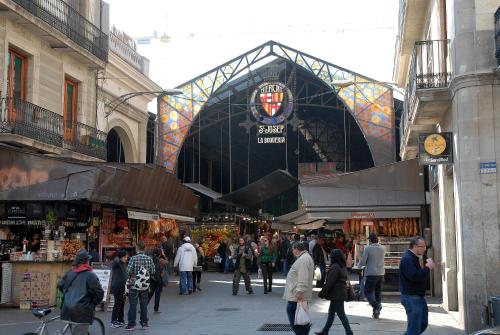 a group of people walking around a street in a market at Moderno in Barcelona
