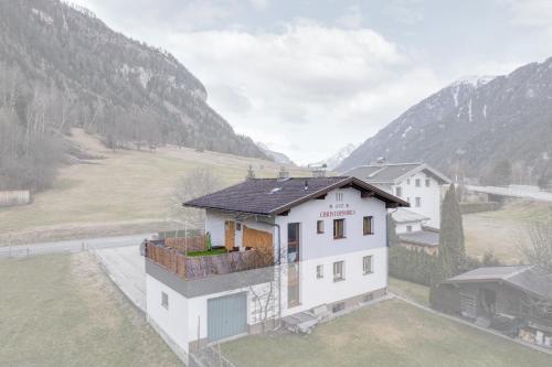 a house in a field with mountains in the background at Sweet Home Apartments in Tösens