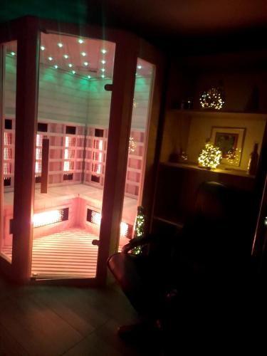 a room with a door open to a balcony with lights at Snežak (Snowman) in Bohinj