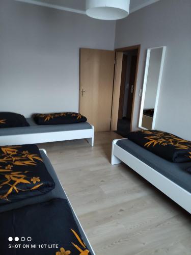 a room with three beds in it at Ferienwohnung Henny in Wismar