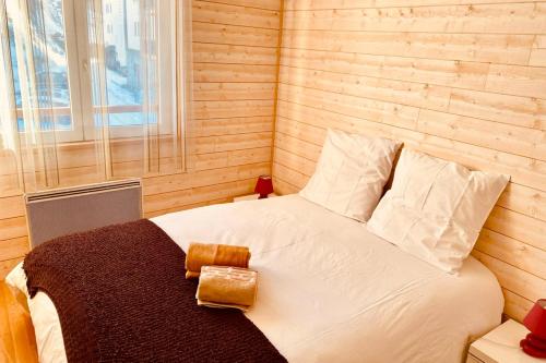 a bedroom with a white bed with a window at 2 room apartment 200m from the slopes In the heart of the ski resort in Valberg