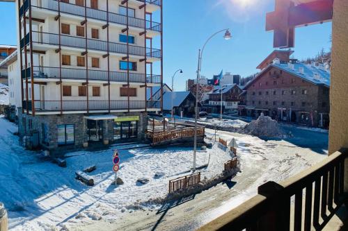 a building in a city with snow on the ground at 2 room apartment 200m from the slopes In the heart of the ski resort in Valberg