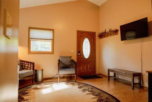 a living room with a door and a table and a rug at Maple Creek Cabin, minutes from Cook Forest, ANF in Marienville