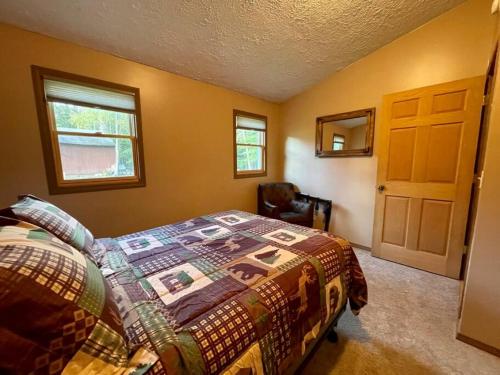 a bedroom with a bed and a chair in it at Maple Creek Cabin, minutes from Cook Forest, ANF in Marienville