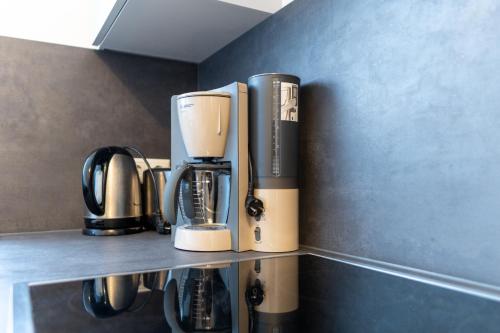 a coffeemaker sitting on top of a shelf at FeWo Bensing in Forchheim