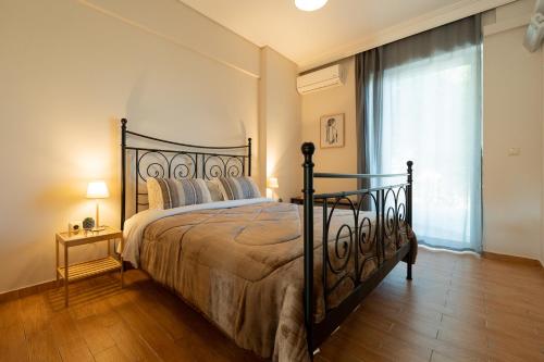 a bedroom with a large bed and a window at Athens Airport Loft in Spata