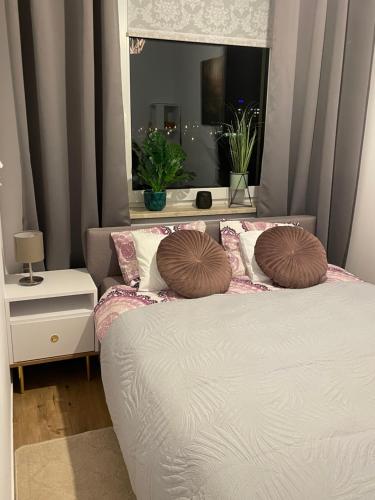 a bedroom with a bed with two pillows on it at NaturaApart bezpłatny parking in Ostrołęka