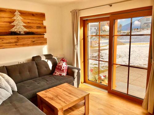 a living room with a couch and a window at Chalet Mama in Pruggern