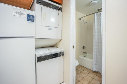 a small bathroom with a refrigerator and a toilet at Hanalei Bay Resort 2301 in Princeville