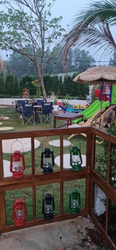 a wooden fence with a playground with a slide at GO GLAMPING MAEPIM CAPE in Ban Nam Lai Ta Tum