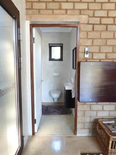 a bathroom with a sink and a toilet in a room at Ibenstein Safaris in Dordabis