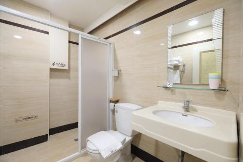 a bathroom with a sink and a toilet and a mirror at 161 Easy Inn in Yuchi