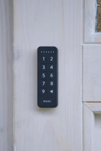 a black remote control on a white door at Sweet Home Apartments in Tösens