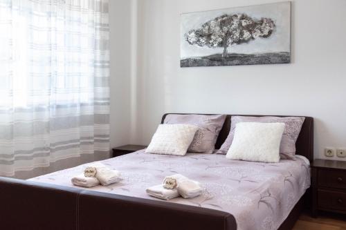 a bedroom with a bed with towels on it at Vacation villa Matic with 7 bedrooms in Sinj