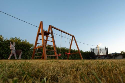 a person is standing next to an empty playground at Vacation villa Matic with 7 bedrooms in Sinj