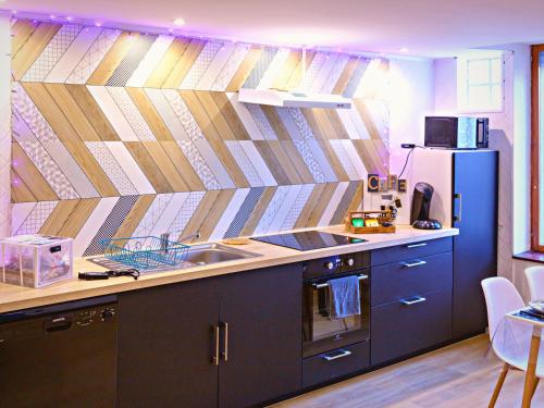 a kitchen with a sink and a refrigerator at LE CONCORDE-WIFI-Clim-Parking-3étoiles-OcKeys in Bram