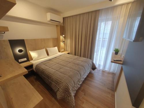 ein Hotelzimmer mit einem Bett und einem Fenster in der Unterkunft EUPHORIA ''Staying in Pleasure'' in Paralia Katerinis