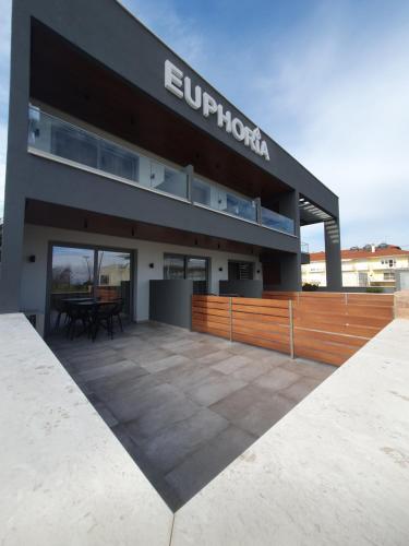 a building with a patio in front of it at EUPHORIA ''Staying in Pleasure'' in Paralia Katerinis