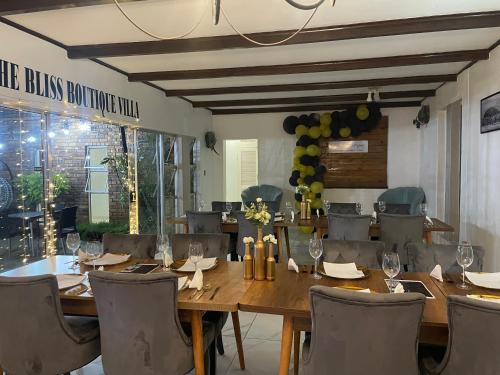 a dining room with a large wooden table and chairs at The Bliss Boutique in Louis Trichardt