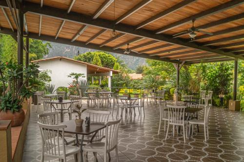 a restaurant with tables and chairs on a patio at Posada La Presa in Tepoztlán