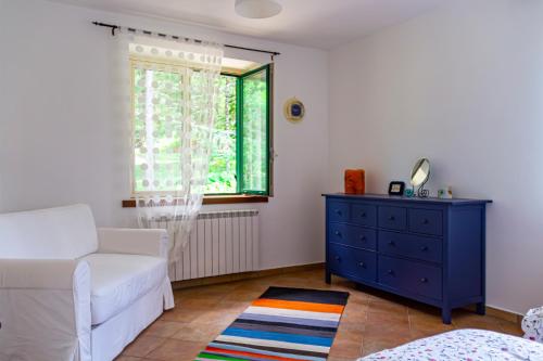 sala de estar con sofá blanco y cómoda azul en Casa Tronola en Villaggio Laceno