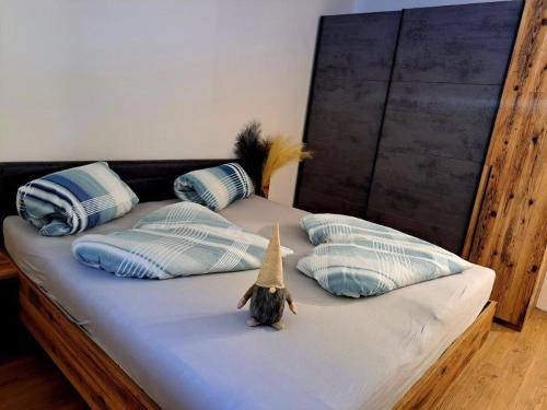 a bed with blue and white pillows with a toy star on it at Mountain JoLe in Neustift im Stubaital