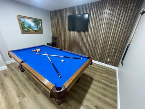 a blue pool table in a room with a tv at Quiet Private House w Hot Tub/Fire pit/Games in Blakeslee
