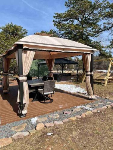 a gazebo with a table and a bench under it at Quiet Private House w Hot Tub/Fire pit/Games in Blakeslee