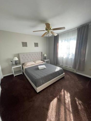 a bedroom with a bed and a ceiling fan at Quiet Private House w Hot Tub/Fire pit/Games in Blakeslee