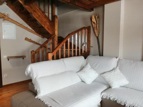 a living room with a couch and a staircase at Precioso triplex con jardín y Wifi Puig Falcó 1 in Pla de l'Ermita