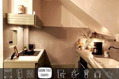 a small kitchen with a stove and a sink at Grand appartement place Saint-Pierre, proche Château de Saumur et bord de Loire" in Saumur
