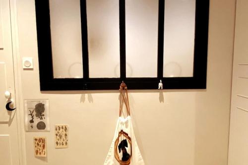 a window on a wall with a boat hanging from it at Grand appartement place Saint-Pierre, proche Château de Saumur et bord de Loire" in Saumur