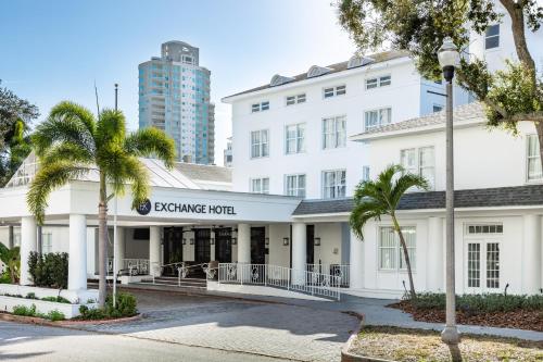 an exterior view of the executive hotel with palm trees at The Exchange Hotel in St Petersburg
