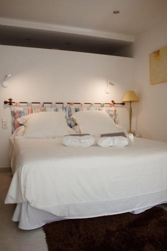 a bedroom with a large white bed with two pillows at Apartamento Catòlics 25 in Pollença