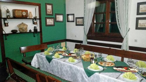 a dining room with a table with plates of food at Hotel Laguna in Podgorica