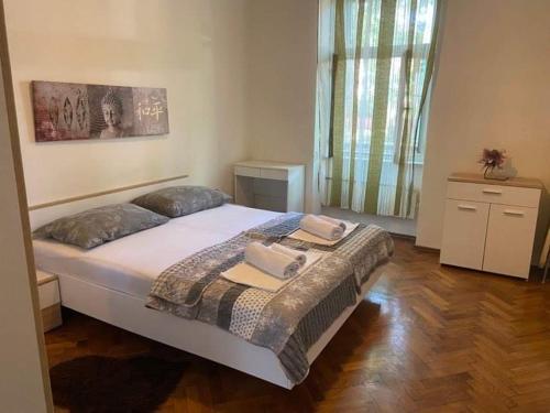 a bedroom with a large bed in a room at Alex in Rijeka