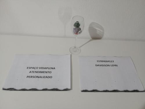 a white vase and a sign on a wall at Studio independente ao lado da praça centro in Chapada dos Guimarães